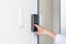 Asian businessman& x27;s hand using fingerprint sensor door lock, modern doorbell with video camera