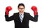 Asian businessman satisfy with red boxing glove