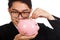Asian businessman smile put a coin to a pink piggy bank