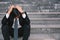 Asian businessmen with headaches or migraines at the city hall after work Images of young businessmen who are tired, stress, crisi