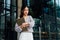 Asian businesswoman checking watch near office building