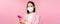 Asian businesswoman in medical face mask using mobile phone. Japenese saleswoman, corporate lady in suit, holding