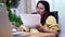 Asian businesswoman online working at home. Thai woman lifestyle in living room. Social distancing