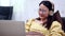 Asian businesswoman online working at home. Thai woman lifestyle in living room. Social distancing