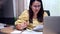 Asian businesswoman online working at home. Thai woman lifestyle in living room. Social distancing