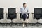 Asian businesswoman sitting in chair waiting for interview