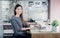 Asian businesswoman typing working on laptop computer and looking screen at office,Office lifestyle concept.