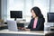 Asian businesswoman using laptop in office