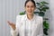 Asian businesswoman in white suit looking at camera, recording self-presentation video or sharing professional skills. Happy