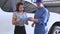 Asian car mechanic and female customer discussing to repairing and maintenance fixing automobile vehicle engine in auto repair