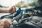 Asian car mechanic holds a wrench and a bottle of lure oil, ready to repair the car