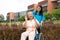 Asian careful caregiver or nurse and the happy patient in a wheelchair are walking in the garden. Concept of happy retirement with