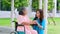 Asian careful caregiver or nurse taking care of the patient in a wheelchair.  Concept of happy retirement with care from a