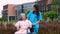 Asian careful caregiver or nurse taking care of the patient in a wheelchair.  Concept of happy retirement with care from a