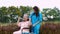 Asian careful caregiver or nurse taking care of the patient in a wheelchair.  Concept of happy retirement with care from a