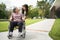 Asian careful caregiver or nurse taking care of the patient in a wheelchair. Concept of happy retirement with care from a