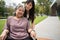 Asian careful caregiver or nurse taking care of the patient in a wheelchair. Concept of happy retirement with care from a