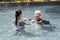 Asian caregiver woman is support,care the elderly people walking,exercising in the water,happy and healthy senior mother in