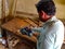 An asian carpenter finishing wood logs at art factory in India January 2020