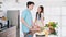 Asian cheerful loving couple talking, preparing and cooking with joy while standing on a kitchen counter at home. Cooking together