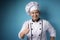 Asian Chef Smiling at Camera and Shows Thumbs Up Gesture