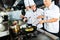 Asian Chefs in restaurant kitchen cooking