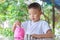 Asian child boy putting coins in to the pink pig can. Childhood insert money in the bottle