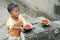 Asian child eating fruit in cambodia