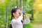 Asian child girl with binoculars in nature fields. Explore and adventure concept
