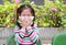 Asian child girl blow her nose on issue paper while sitting outdoor