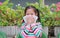 Asian child girl blow her nose on issue paper while sitting outdoor