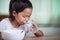 Asian child girl eating delicious instant noodles and drinking the glass of water for her lunch in the house