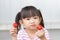 Asian child girl enjoy eating and biting strawberry fruit.