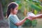 Asian child girl getting adorable bunny from her mother hand and she  playing and caring cute little rabbit holland lop