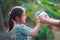 Asian child girl getting adorable bunny from her mother hand and she  playing and caring cute little rabbit holland lop