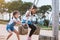 Asian child girl having fun to play on wooden swings with her sister in playground with beautiful nature