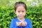 Asian child girl holding some thai sugar and fruit toffee with colorful paper wrapped in her hands. Focus at candy in her hands