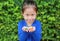 Asian child girl holding some thai sugar and fruit toffee with colorful paper wrapped in her hands. Focus at candy in her hands