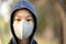 Asian child girl in hood and wearing cotton mask,protection from Covid-19 virus,prevent infection of Coronavirus,pandemic of