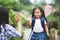 Asian child girl with school bag and her mother making hi five