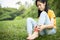 Asian child girl scratching itch on her leg with hand,female teenage with red rash,mosquito bite,fungal infection,insect bites,