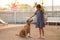 Asian child girl stroking a dog at home with kind and love