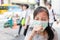 Asian child girl suffer from cough with face mask protection,sick female teen wearing medical mask because of air pollution in the