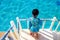 Asian child girl in swimsuit standing on the top and holding floating foam