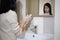 Asian child girl washing hands with soap on sink in the bathroom, female teenage with wash hands thoroughly after excretion,