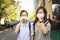 Asian child girl wearing medical mask in public area at risk of disease,people with mask  in city street prevent infection from