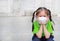 Asian child girl wearing a protection mask while outside to against PM 2.5 air pollution with pointing up in Bangkok city.