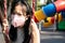 Asian child girl wearing protective mask,problems of toxic smog,fine dust,air pollution,PM2.5,Bangkok in air pollution,danger to