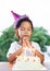 Asian child girls make folded hand to wish the good things for her birthday in birthday party