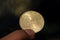 Asian child hand holding a Fifty Halalas Riyal coin, Saudi Arabia money, selected focus and dark background